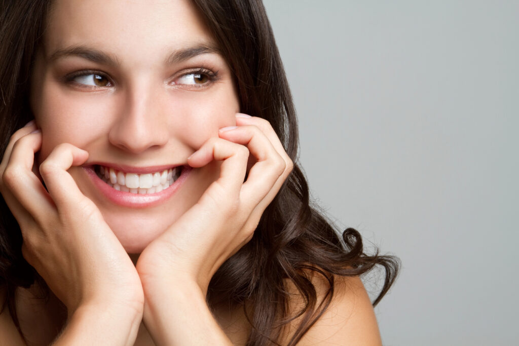 Woman smiling after visiting an orthodontic office