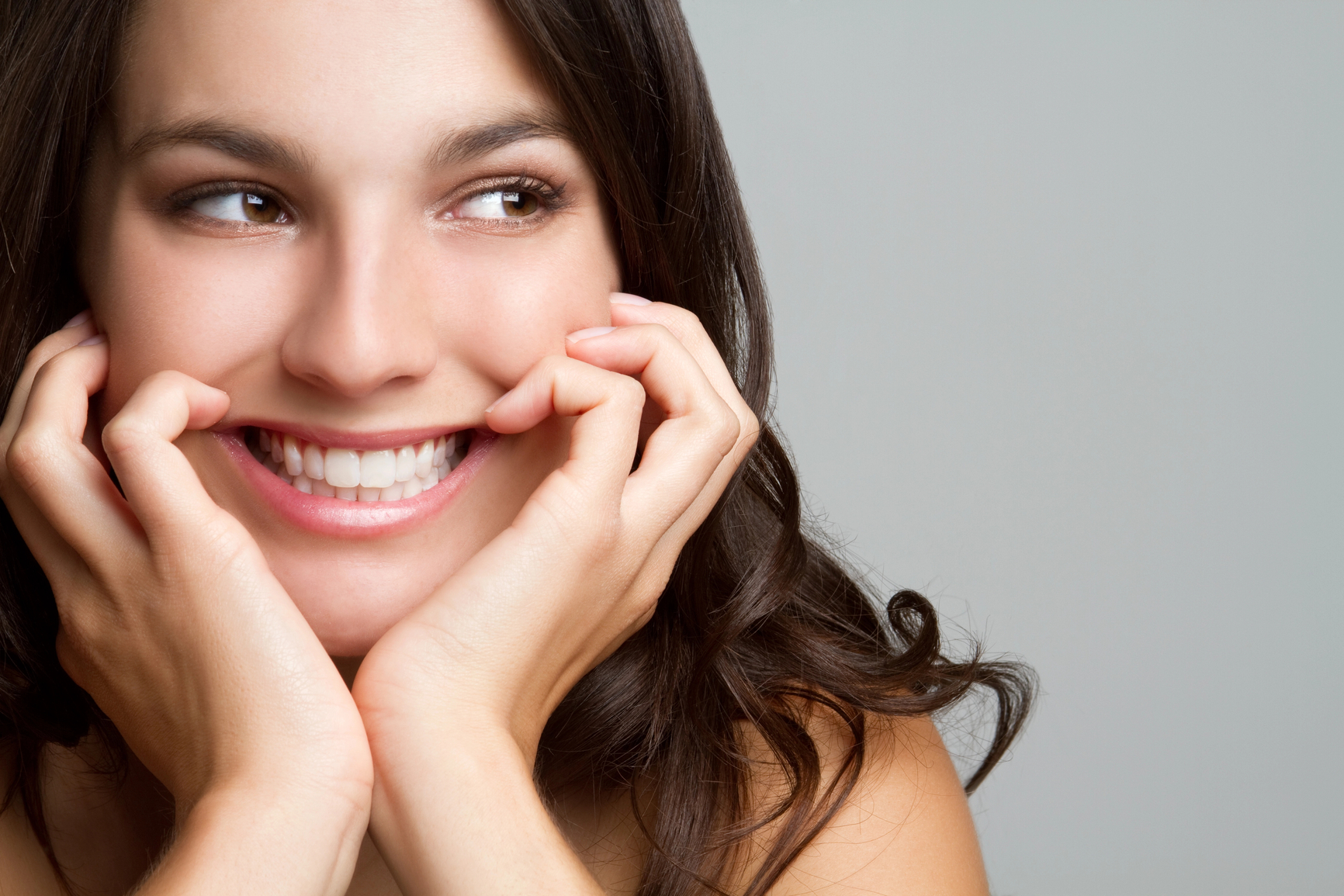 Woman smiling after visiting an orthodontic office